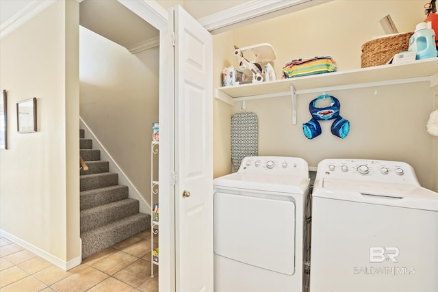 washroom with washer and clothes dryer, tile patterned flooring, and ornamental molding