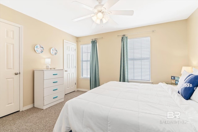 bedroom with light carpet and ceiling fan