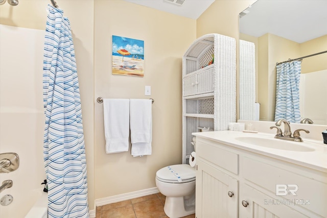 bathroom with toilet, vanity, and tile patterned floors