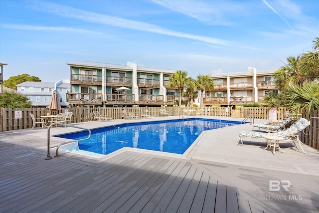 view of swimming pool with a wooden deck