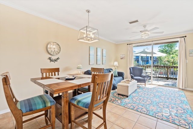 dining area with ceiling fan with notable chandelier, light tile patterned floors, and crown molding