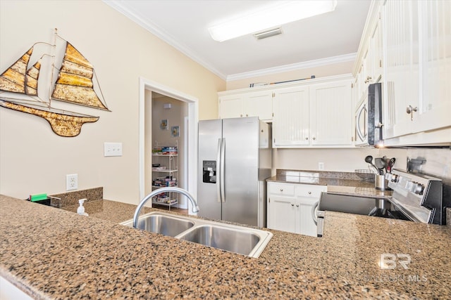 kitchen featuring sink, ornamental molding, appliances with stainless steel finishes, white cabinetry, and kitchen peninsula