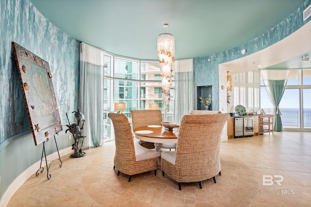 26302 Perdido Beach Blvd Unit D2201, Orange Beach, AL 36561 - dining room featuring wallpapered walls, beverage cooler, and tile patterned floors