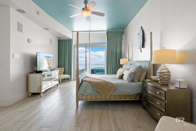 26302 Perdido Beach Blvd Unit D2201, Orange Beach, AL 36561 - bedroom with a wall of windows, wood finished floors, and ceiling fan