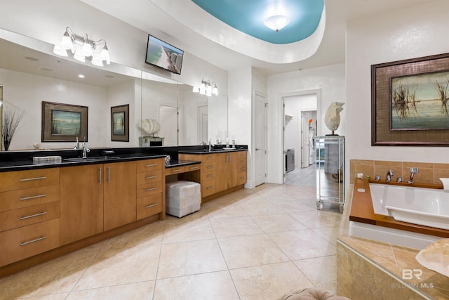 26302 Perdido Beach Blvd Unit D2201, Orange Beach, AL 36561 - bathroom with vanity, a tub to relax in, tile patterned flooring, and baseboards