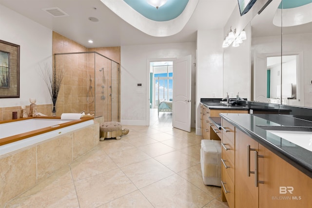 26302 Perdido Beach Blvd Unit D2201, Orange Beach, AL 36561 - bathroom featuring vanity, a stall shower, a bath, tile patterned flooring, and baseboards