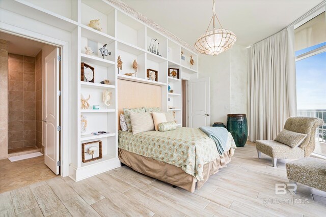 26302 Perdido Beach Blvd Unit D2201, Orange Beach, AL 36561 - bedroom with light wood finished floors and a chandelier