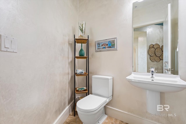 26302 Perdido Beach Blvd Unit D2201, Orange Beach, AL 36561 - bathroom featuring toilet, baseboards, a sink, and tile patterned floors
