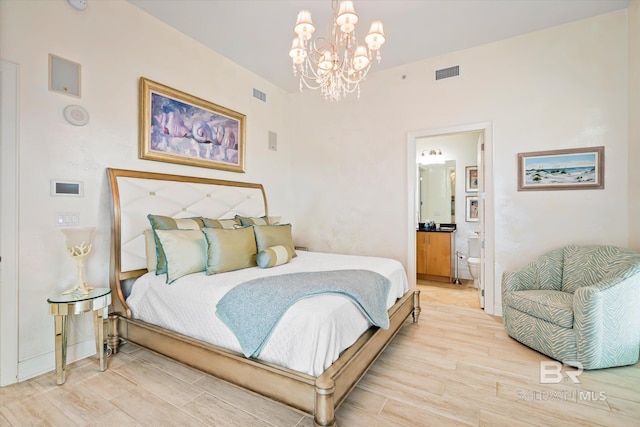 26302 Perdido Beach Blvd Unit D2201, Orange Beach, AL 36561 - bedroom with a chandelier, connected bathroom, and light wood-style flooring