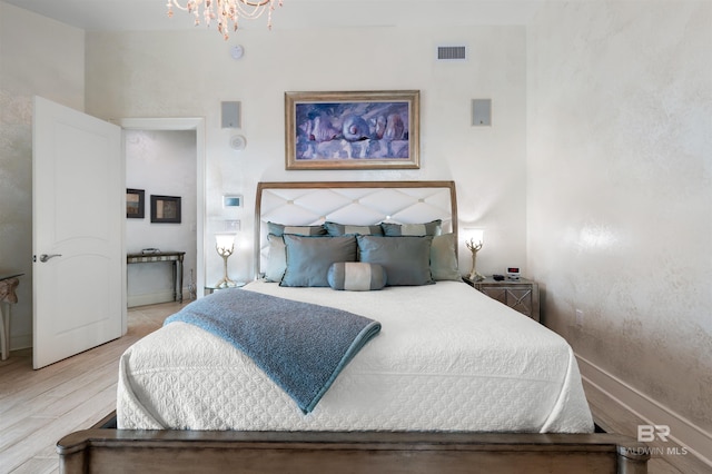 26302 Perdido Beach Blvd Unit D2201, Orange Beach, AL 36561 - bedroom with a chandelier, light wood finished floors, and baseboards