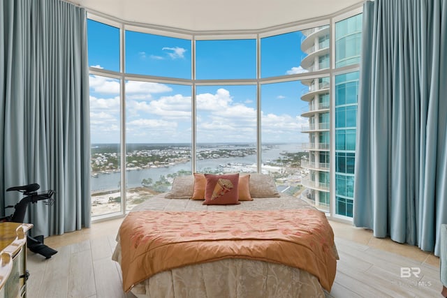 26302 Perdido Beach Blvd Unit D2201, Orange Beach, AL 36561 - bedroom featuring a water view, floor to ceiling windows, multiple windows, and light wood finished floors