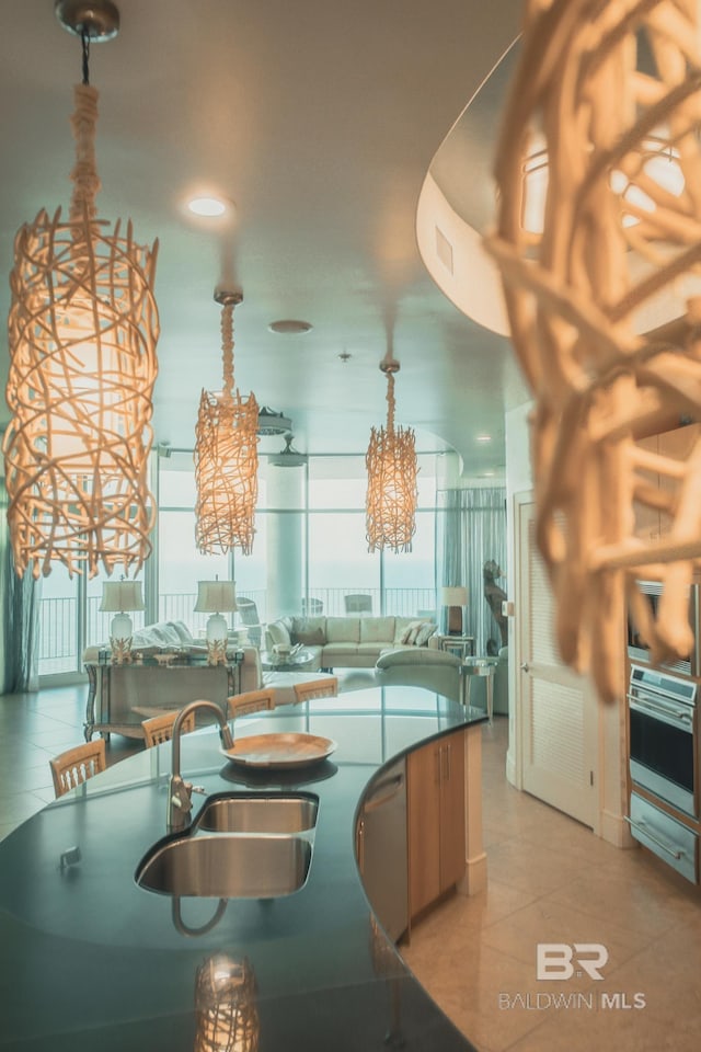26302 Perdido Beach Blvd Unit D2201, Orange Beach, AL 36561 - kitchen featuring a sink, a chandelier, appliances with stainless steel finishes, pendant lighting, and dark countertops