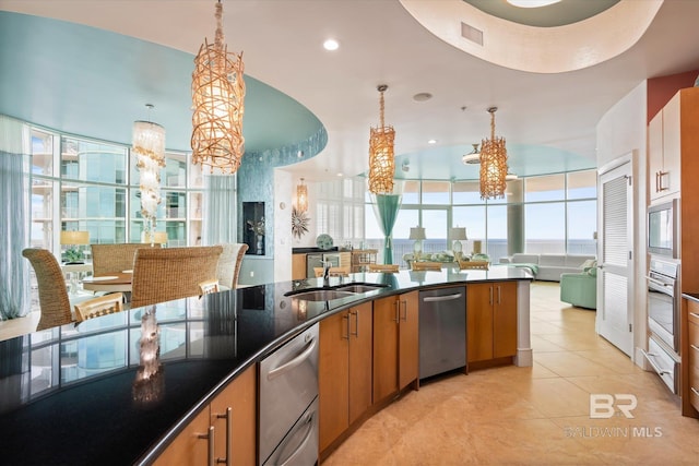 26302 Perdido Beach Blvd Unit D2201, Orange Beach, AL 36561 - kitchen featuring a sink, a chandelier, appliances with stainless steel finishes, brown cabinets, and open floor plan