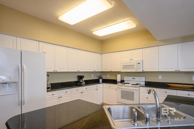 kitchen featuring white cabinetry, sink, and white appliances