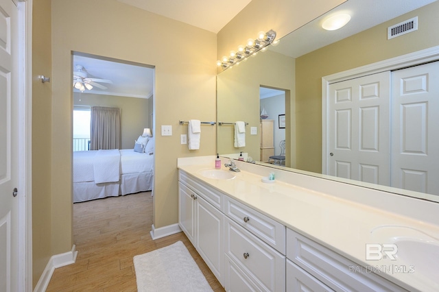 bathroom featuring ceiling fan, wood-type flooring, and vanity