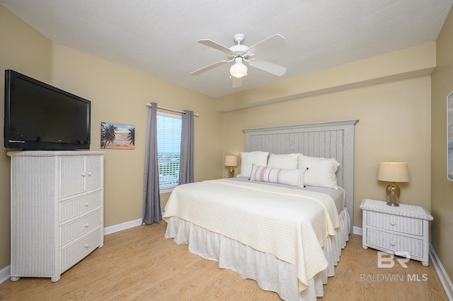 bedroom with ceiling fan and light wood-type flooring