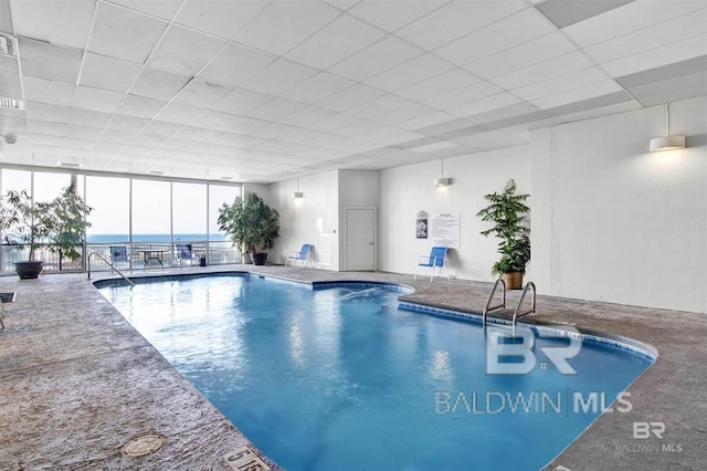 view of swimming pool featuring a water view