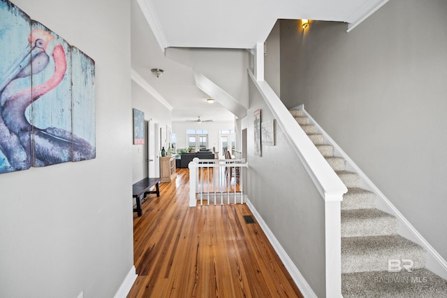 interior space with hardwood / wood-style floors and ornamental molding