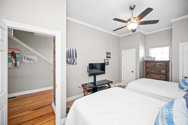 bedroom with hardwood / wood-style flooring, ceiling fan, and crown molding