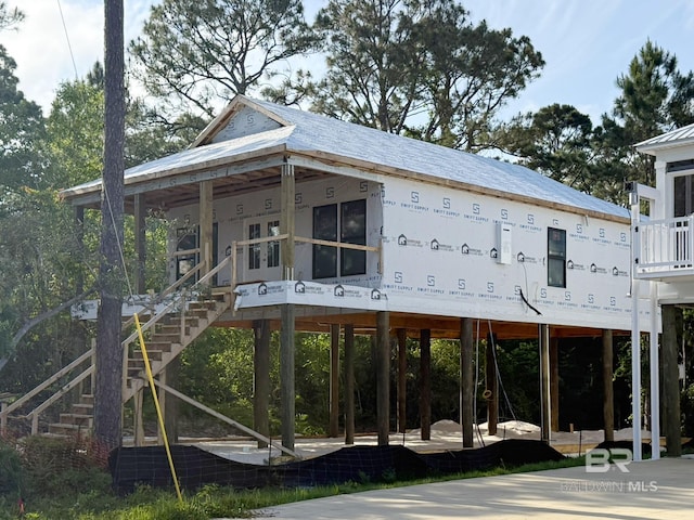 rear view of property with stairs