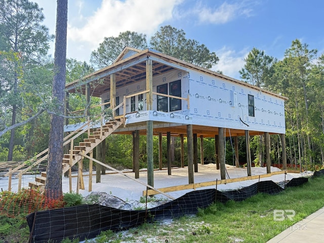 exterior space with a carport and stairs
