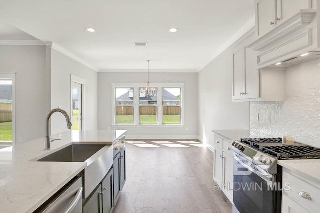384 Garrison Blvd, Fairhope, AL 36532 - kitchen featuring stainless steel appliances, light stone counters, decorative backsplash, custom range hood, and light wood finished floors