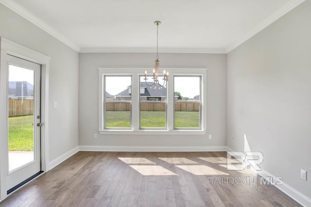 384 Garrison Blvd, Fairhope, AL 36532 - unfurnished dining area with a chandelier, wood finished floors, and crown molding