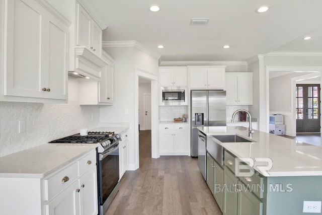 384 Garrison Blvd, Fairhope, AL 36532 - kitchen featuring appliances with stainless steel finishes, white cabinetry, crown molding, decorative backsplash, and recessed lighting