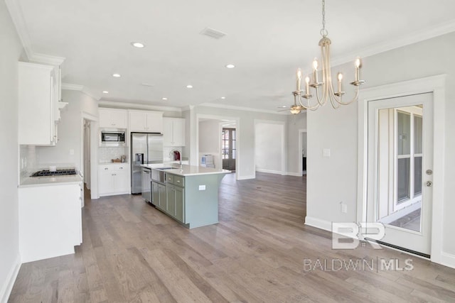 384 Garrison Blvd, Fairhope, AL 36532 - kitchen with stainless steel appliances, ornamental molding, light countertops, wood finished floors, and white cabinetry
