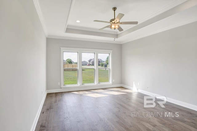 384 Garrison Blvd, Fairhope, AL 36532 - spare room featuring a tray ceiling, wood finished floors, ornamental molding, and ceiling fan