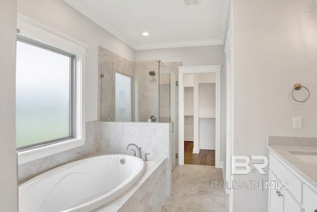 384 Garrison Blvd, Fairhope, AL 36532 - bathroom featuring a shower stall, a garden tub, vanity, a spacious closet, and crown molding