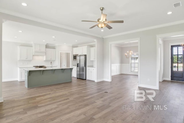 384 Garrison Blvd, Fairhope, AL 36532 - kitchen with stainless steel appliances, a kitchen bar, white cabinets, a chandelier, and light countertops