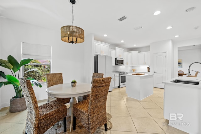 tiled dining area featuring sink