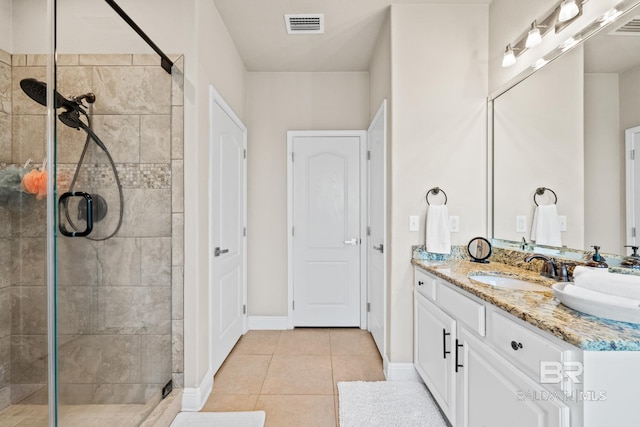 bathroom with vanity with extensive cabinet space, an enclosed shower, and tile floors