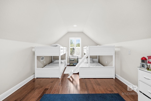 bedroom with dark wood-type flooring and vaulted ceiling