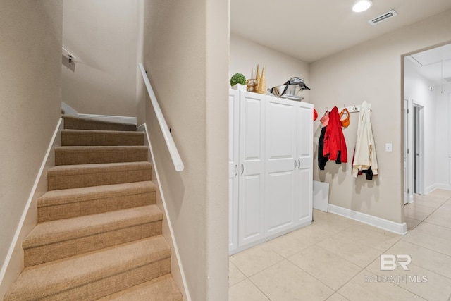 stairs featuring light tile flooring