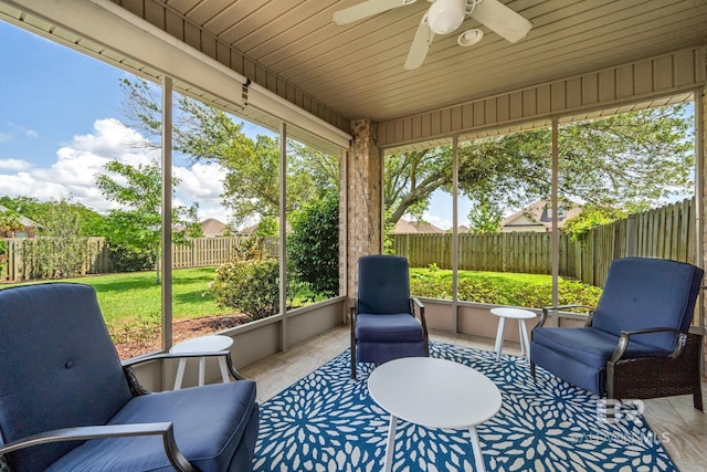 sunroom featuring ceiling fan