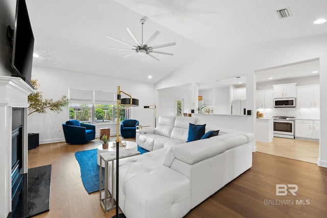 tiled living room with high vaulted ceiling and ceiling fan