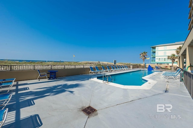 view of swimming pool with a patio