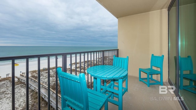 balcony with a view of the beach and a water view