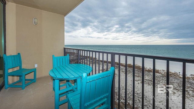 balcony with a view of the beach and a water view