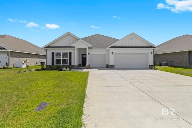 view of front of home featuring driveway, board and batten siding, an attached garage, central AC, and a front yard