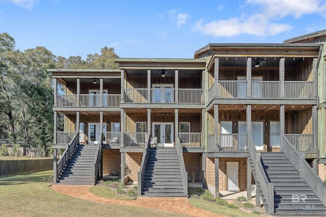 view of front facade featuring stairway, french doors, and a ceiling fan