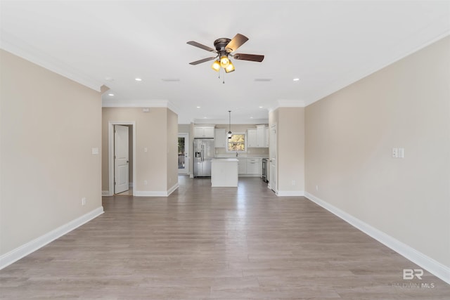 unfurnished living room with baseboards, recessed lighting, ornamental molding, ceiling fan, and light wood-style floors