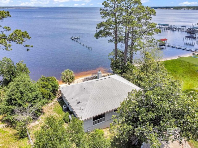 view of property hidden behind natural elements with a garage and a front yard