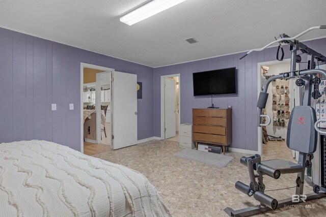 bedroom featuring a textured ceiling and ensuite bathroom