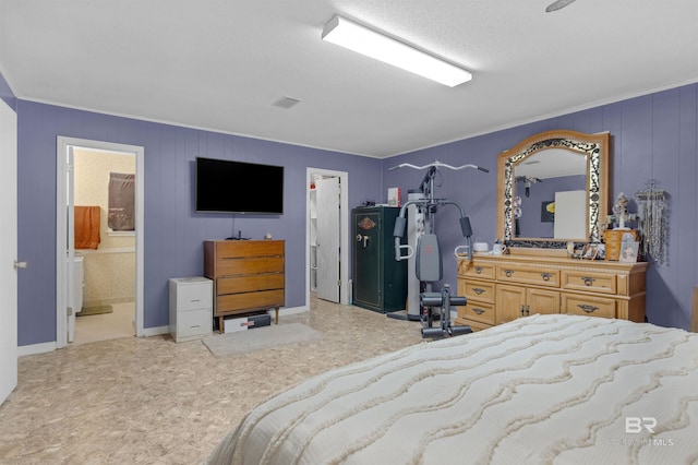 bedroom featuring ensuite bath and visible vents