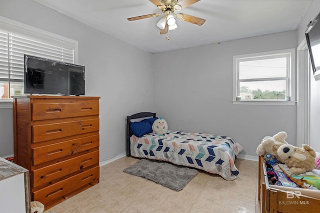bedroom featuring baseboards and ceiling fan