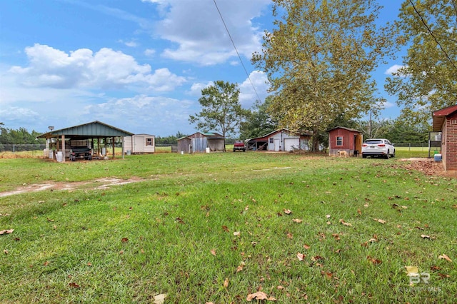 view of yard with an outbuilding and fence