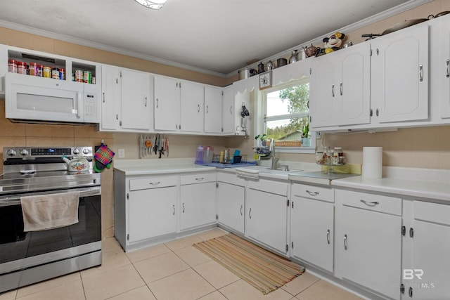 kitchen with white microwave, electric range, white cabinetry, and crown molding